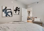 Thumbnail 38 of 83 - a bedroom with a bed and a mirror.. Circle Pines, MN Lexington Lofts