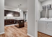 Thumbnail 41 of 83 - a washer and dryer in a room with a kitchen. Circle Pines, MN Lexington Lofts