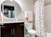 Thumbnail 31 of 83 - a bathroom with a shower and a toilet and a sink. Circle Pines, MN Lexington Lofts