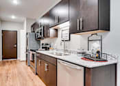 Thumbnail 28 of 83 - a kitchen with a counter top and a sink. Circle Pines, MN Lexington Lofts