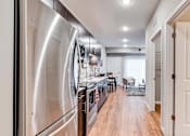 Thumbnail 29 of 83 - a kitchen with stainless steel appliances and a door to a living room. Circle Pines, MN Lexington Lofts