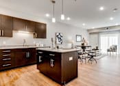 Thumbnail 6 of 83 - an open kitchen and living room with a dining room table. Circle Pines, MN Lexington Lofts
