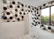 Thumbnail 71 of 83 - a bathroom with black and white tiles on the wall. Circle Pines, MN Lexington Lofts
