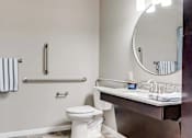 Thumbnail 25 of 83 - a bathroom with a toilet and a sink and a mirror. Circle Pines, MN Lexington Lofts