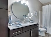 Thumbnail 20 of 83 - a bathroom with a sink and a toilet and a mirror. Circle Pines, MN Lexington Lofts