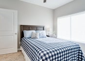 Thumbnail 18 of 83 - a bedroom with a bed and a large window. Circle Pines, MN Lexington Lofts
