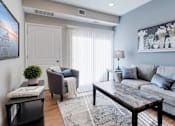 Thumbnail 14 of 83 - a living room with a couch and a table. Circle Pines, MN Lexington Lofts