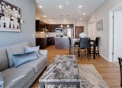 Thumbnail 15 of 83 - a living room and kitchen with a couch and a table. Circle Pines, MN Lexington Lofts