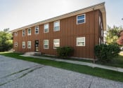 Thumbnail 8 of 8 - Grand Forks, ND Claremont Apartments. brick exterior of the two-level apartments building
