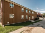 Thumbnail 7 of 8 - Grand Forks, ND Claremont Apartments. brick exterior of the two-level apartment building
