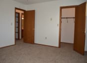 Thumbnail 5 of 6 - A bedroom with two doors and a closet