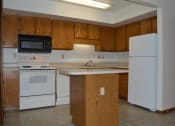 Thumbnail 4 of 6 - a kitchen with white appliances and wooden cabinets