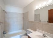 Thumbnail 10 of 14 - a bathroom with a sink toilet and a bath tub. Coon Rapids, MN Robinwood Apartments