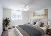 Thumbnail 4 of 14 - a bedroom with a bed and a ceiling fan. Coon Rapids, MN Robinwood Apartments
