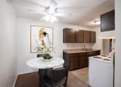 Thumbnail 3 of 14 - our apartments offer a kitchen and living room with a round table. Coon Rapids, MN Robinwood Apartment