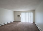 Thumbnail 5 of 14 - the living room of an apartment with a large window and white walls. Coon Rapids, MN Robinwood Apartments