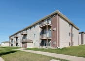 Thumbnail 44 of 44 - an apartment building with a sidewalk in front of it. Fargo, ND Country Edge Apartments