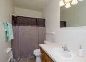 Thumbnail 27 of 42 - a bathroom with a shower and a sink and a toilet. Fargo, ND Country Club Apartments.