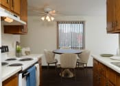 Thumbnail 6 of 23 - a kitchen and dining room with a table and chairs. Fargo, ND Countryside Apartments