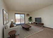 Thumbnail 5 of 23 - the living room of an apartment with a couch and a tv. Fargo, ND Countryside Apartments