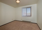 Thumbnail 10 of 23 - the living room of an apartment with a window and carpet. Fargo, ND Countryside Apartments