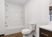 Thumbnail 12 of 14 - St. Louis Park, MN Courtyard Apartments. A bathroom with a toilet sink and bathtub