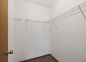 Thumbnail 11 of 14 - St. Louis Park, MN Courtyard Apartments. A walk in closet with shelves for storage or hanging clothes