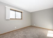 Thumbnail 7 of 14 - St. Louis Park, MN Courtyard Apartments. An empty bedroom with a window and carpet