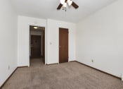 Thumbnail 7 of 9 - West St. Paul, MN Covington Courts Apartments. A  bedroom with a ceiling fan and a door to a hallway