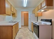 Thumbnail 5 of 10 - a kitchen with white appliances. Fargo, ND Dakota Manor Apartments