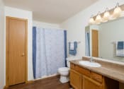 Thumbnail 10 of 11 - a bathroom with a shower and a toilet and a sink. Fargo, ND Danbury Apartments