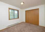 Thumbnail 6 of 11 - a bedroom with carpet and a door to a closet. Fargo, ND Danbury Apartments