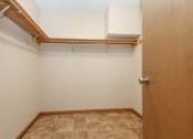 Thumbnail 12 of 29 - Anoka, MN Dellwood Estates Apartments. a large walk in closet in a bedroom with a tiled floor