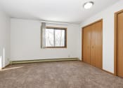 Thumbnail 22 of 29 - an empty room with carpet and a window and a door. Anoka, MN Dellwood Estates