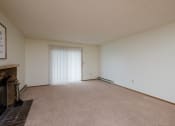Thumbnail 5 of 12 - a living room with a fireplace and a sliding glass door. Fargo, ND Dynasty Apartments