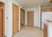 Thumbnail 5 of 21 - an entryway with a door and kitchen with a closet