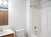 Thumbnail 37 of 42 - a bathroom with a toilet and a sink and a shower.  Eagan, MN Glen Pond Apartments