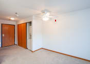 Thumbnail 35 of 42 - a empty room with a ceiling fan and a closet.  Eagan, MN Glen Pond Apartments