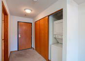 Thumbnail 36 of 42 - a laundry room with a washer and dryer and a door to a closet.  Eagan, MN Glen Pond Apartments
