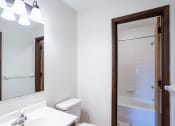 Thumbnail 31 of 42 - a bathroom with a mirror and a toilet and a shower.  Eagan, MN Glen Pond Apartments
