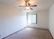 Thumbnail 27 of 42 - a bedroom of an empty apartment with a ceiling fan.  Eagan, MN Glen Pond Apartments