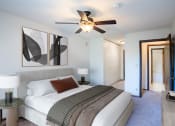 Thumbnail 2 of 42 - a bedroom with a large bed and a ceiling fan. Eagan, MN Glen Pond Apartments