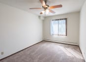 Thumbnail 19 of 42 - a bedroom with a ceiling fan and a window. Eagan, MN Glen Pond Apartments