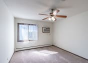 Thumbnail 21 of 42 - a bedroom with a ceiling fan and a window. Eagan, MN Glen Pond Apartments