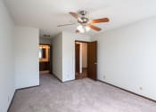 Thumbnail 22 of 42 - a bedroom with a ceiling fan and white walls. Eagan, MN Glen Pond Apartments