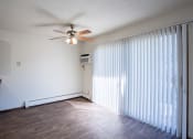 Thumbnail 18 of 42 - a dining room with curtains and a ceiling fan. Eagan, MN Glen Pond Apartments