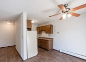 Thumbnail 17 of 42 - an empty kitchen with a ceiling fan and a refrigerator. Eagan, MN Glen Pond Apartments