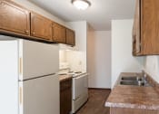 Thumbnail 16 of 42 - an empty kitchen with white appliances and wooden cabinets. Eagan, MN Glen Pond Apartments