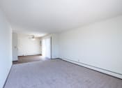 Thumbnail 14 of 42 - a living room with white walls and carpet and a ceiling fan. Eagan, MN Glen Pond Apartments