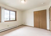 Thumbnail 10 of 14 - a bedroom with white walls and a large window